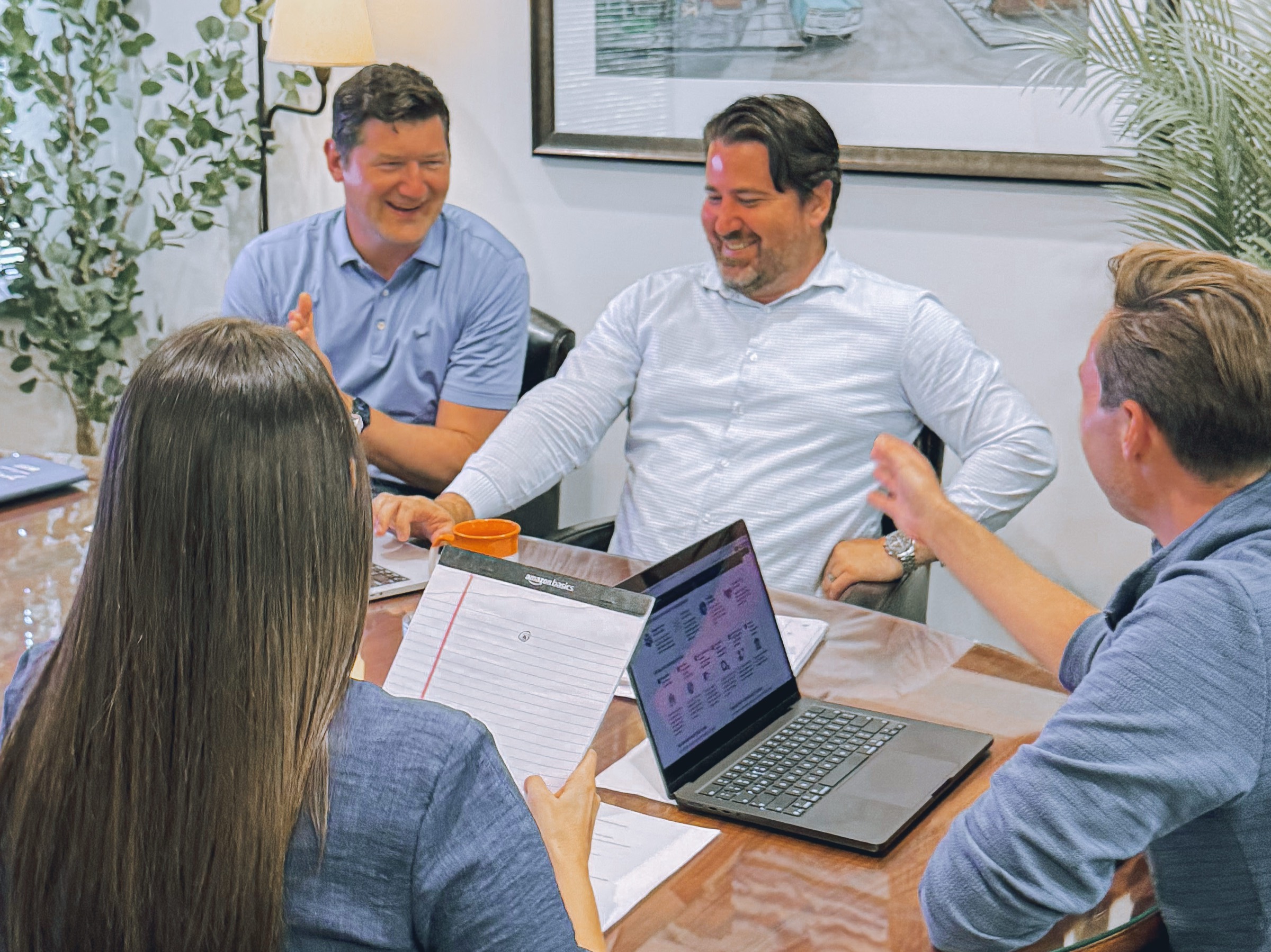 Bond Financial team members talking around the conference table